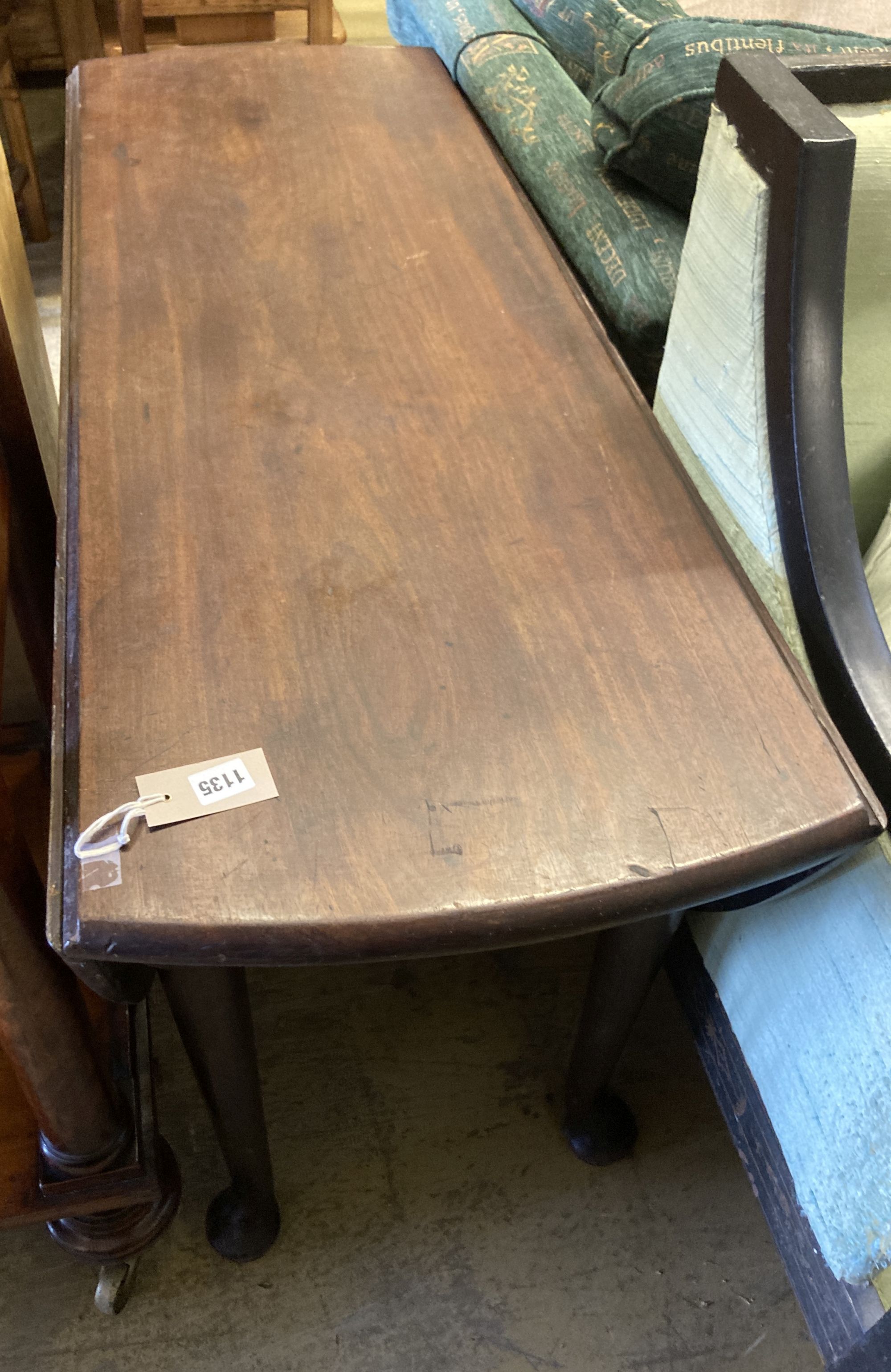 A George III oval mahogany drop leaf pad foot dining table, 142cm extended, width 122cm, height 71cm (in need of restoration)